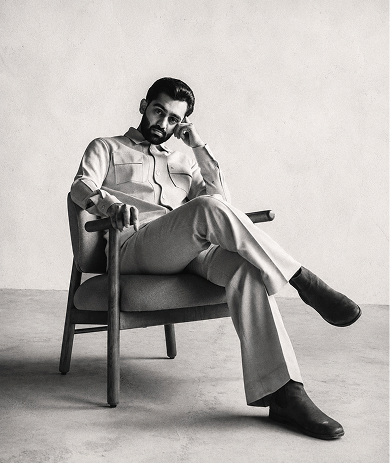 Dhyey, seated in an armchair